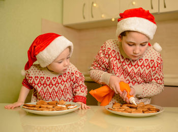 Cute kids making cookie for santa in home kitchen. homemade baking