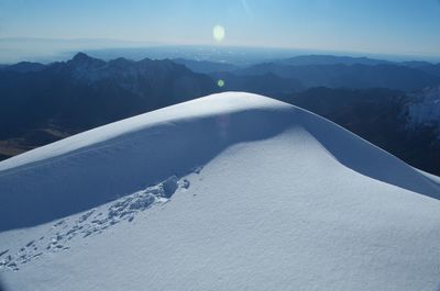 Scenic view of snow covered mountains against sky