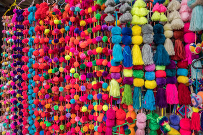 Full frame shot of multi colored pompoms for sale in market