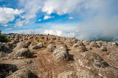 View of rock formations on mountain against sky