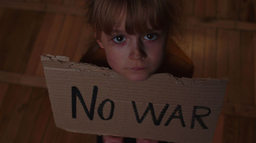 Portrait of boy with text on table