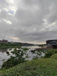 Scenic view of sea by buildings against sky