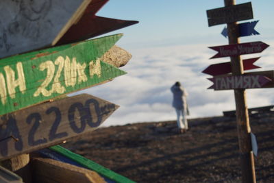 Close-up of road sign against sky