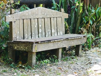 Close-up of old bench in field