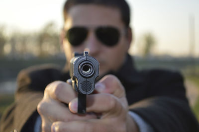 Portrait of man holding gun