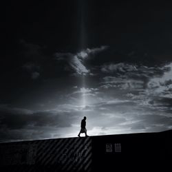 People standing against cloudy sky