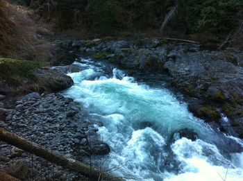 Scenic view of river flowing through rocks