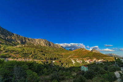 Scenic view of mountains against clear blue sky