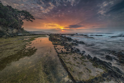 Scenic view of beach against sky during sunset