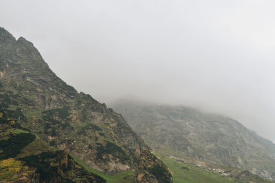 Scenic view of mountains against cloudy sky