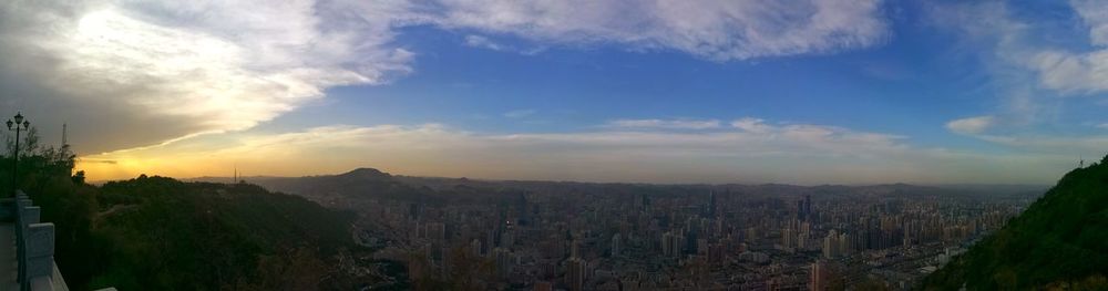 Panoramic view of city buildings against sky