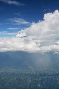 Aerial view of rainbow over landscape against sky