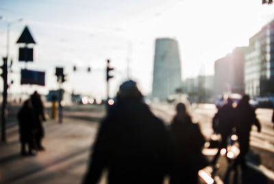 Defocused image of people walking on street in city