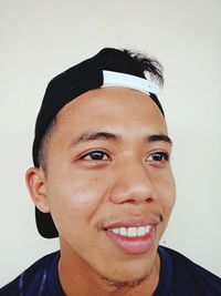 Portrait of smiling young man against white background