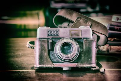 Close-up of old vintage camera on table