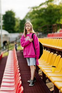 Full length of young woman standing in park