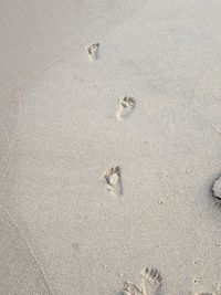 High angle view of footprints on sand