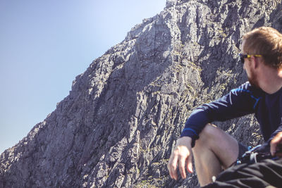 Rear view of man on rock in mountains