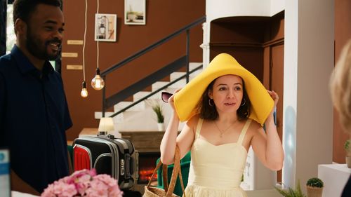 Portrait of young woman holding food at home