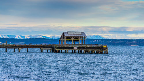 Built structure by sea against sky