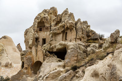 Low angle view of rock formation against sky