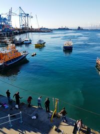 High angle view of people on steps by harbor