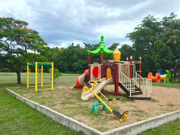 Playground in park against sky