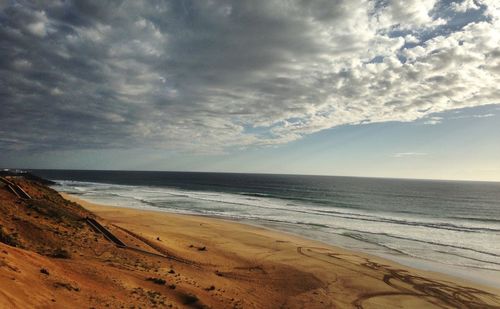 Scenic view of sea against storm clouds