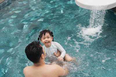 High angle view of boy swimming in water