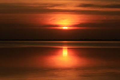 Scenic view of sea against orange sky