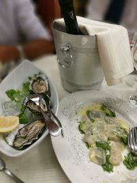 Seafood with wine bottle on table at restaurant