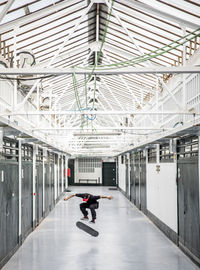 Man walking in corridor of building