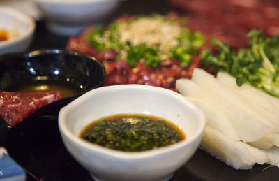 Close-up of beef sashimi with sauce on table