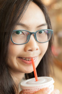 Portrait of young woman having drink