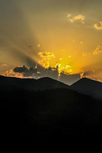 Scenic view of silhouette mountain against sky during sunset