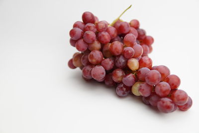 Close-up of grapes against white background