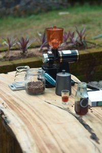 A set of manual coffee brewing tools on a wooden table