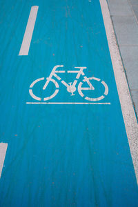 Bicycle lane or bike road sign on blue background.