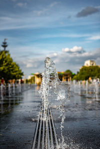 Close-up of frozen water fountain against sky