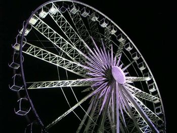 Low angle view of ferris wheel at night