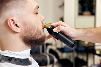 Side view of man drinking water