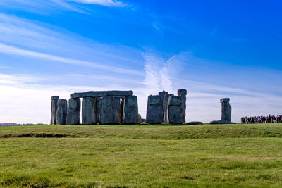 Built structure on field against sky