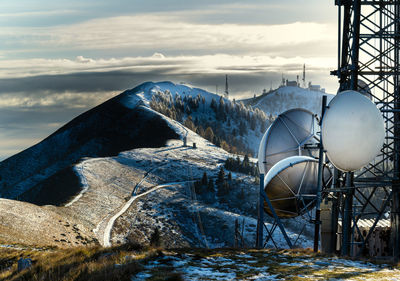 Mountain winter landscape. antenna against cloudy sky. alpe del nevegal, belluno, italy