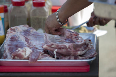 Chef cutting beef in kitchen counter