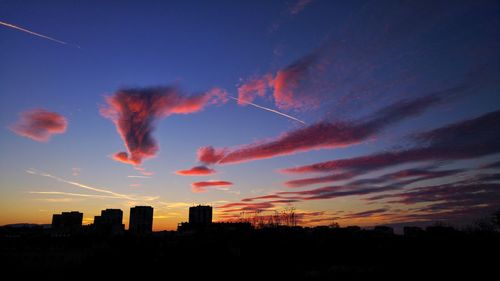 Low angle view of silhouette buildings against sky during sunset