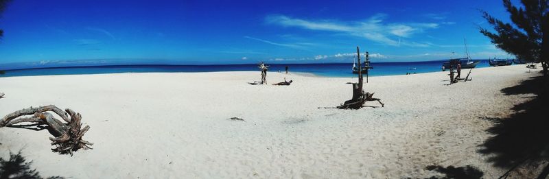 Scenic view of beach against blue sky