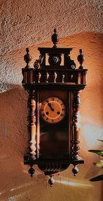 Low angle view of clock on wall