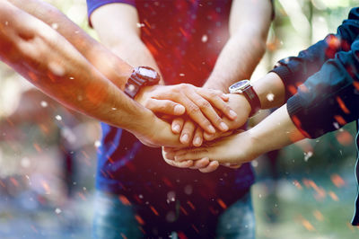 Close-up of people stacking hands