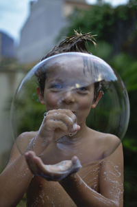 Boy blowing a bubble