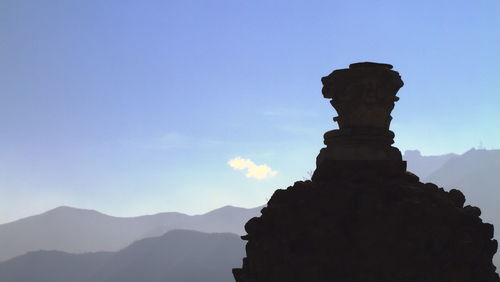 Low angle view of silhouette statue against sky